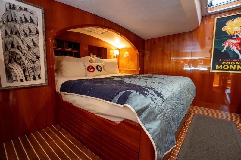 Tehiya Yacht Photos Pics Luxurious 2009 Privilege 615 yacht cabin with elegant wood paneling and cozy bedding.