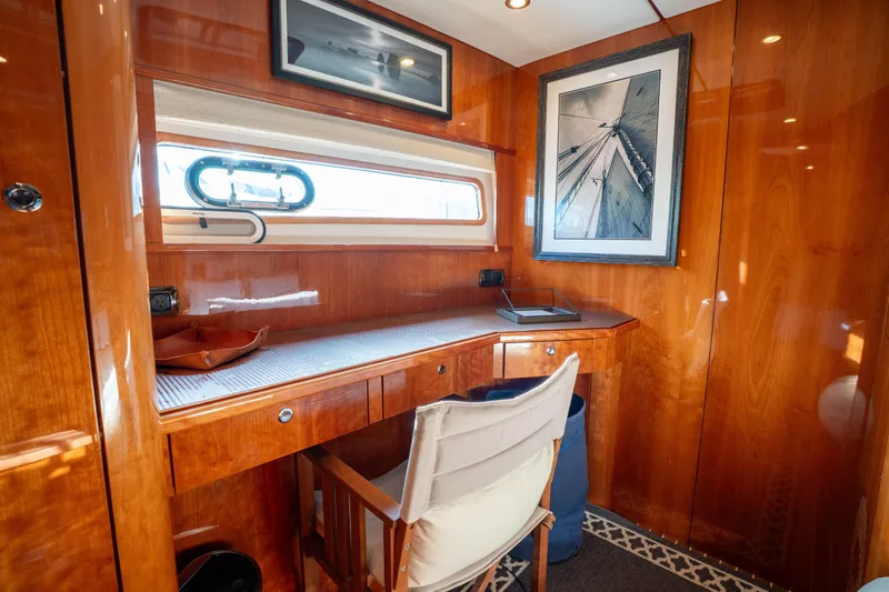 Tehiya Yacht Photos Pics Luxurious wooden interior of 2009 Privilege 615 yacht with desk and artwork.