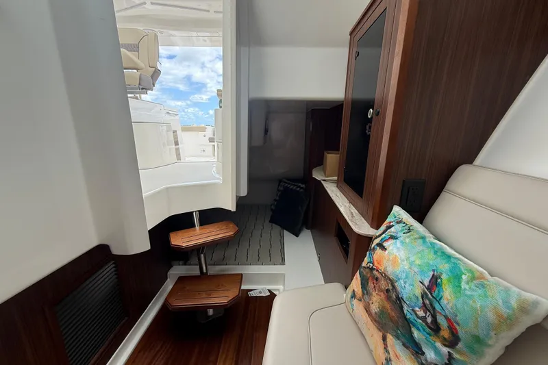  Yacht Photos Pics Interior of 2019 Pursuit DC 365 Dual Console boat with seating and wooden cabinetry.