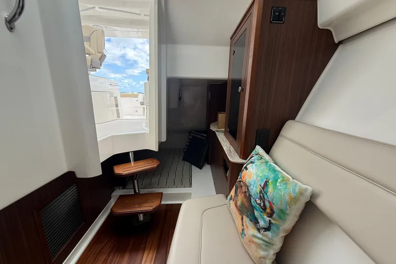  Yacht Photos Pics Interior of 2019 Pursuit DC 365 Dual Console boat with seating and wooden accents.