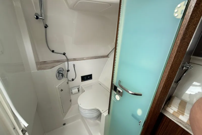 Yacht Photos Pics 2019 Pursuit DC 365 Dual Console boat bathroom with shower and toilet.