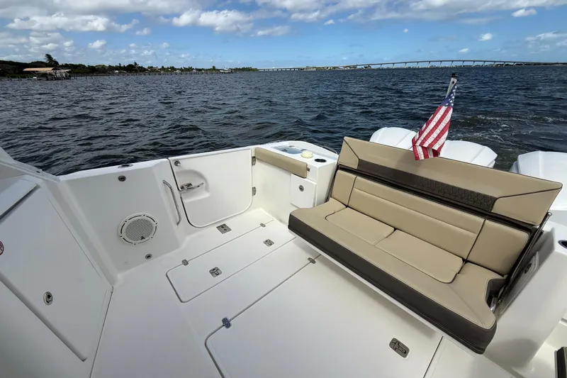  Yacht Photos Pics 2019 Pursuit DC 365 Dual Console boat with seating, American flag, and ocean view.