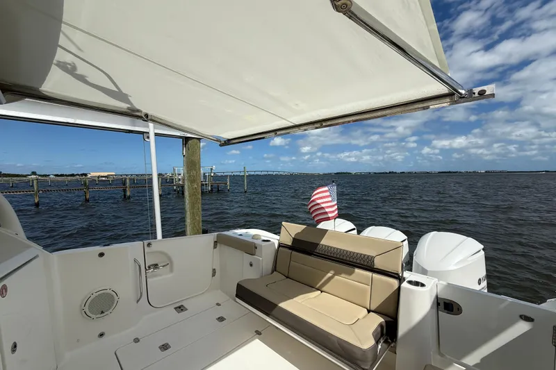  Yacht Photos Pics 2019 Pursuit DC 365 Dual Console boat with seating, awning, and water view.