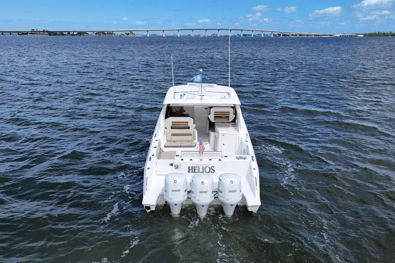  Yacht Photos Pics 2019 Pursuit DC 365 Dual Console boat on open water, bridge in background.