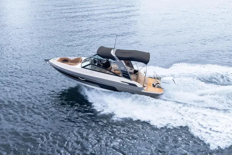  Yacht Photos Pics 2025 Hanover 255 boat cruising on open water with a sleek design and canopy.