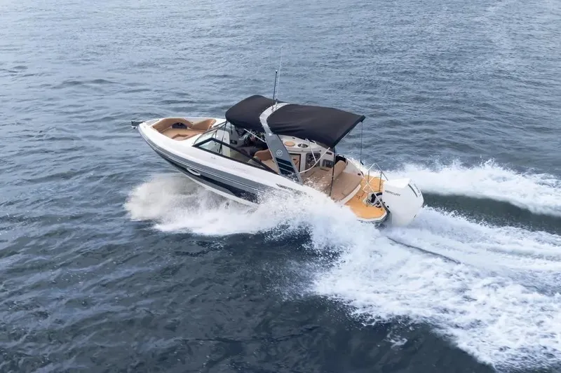  Yacht Photos Pics 2025 Hanover 255 boat cruising on open water with a black canopy.