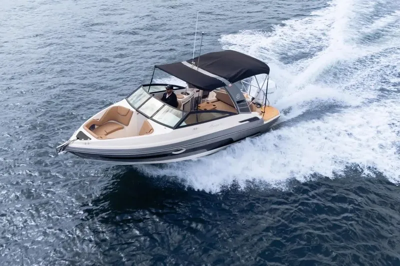  Yacht Photos Pics 2025 Hanover 255 boat cruising on open water with black canopy.