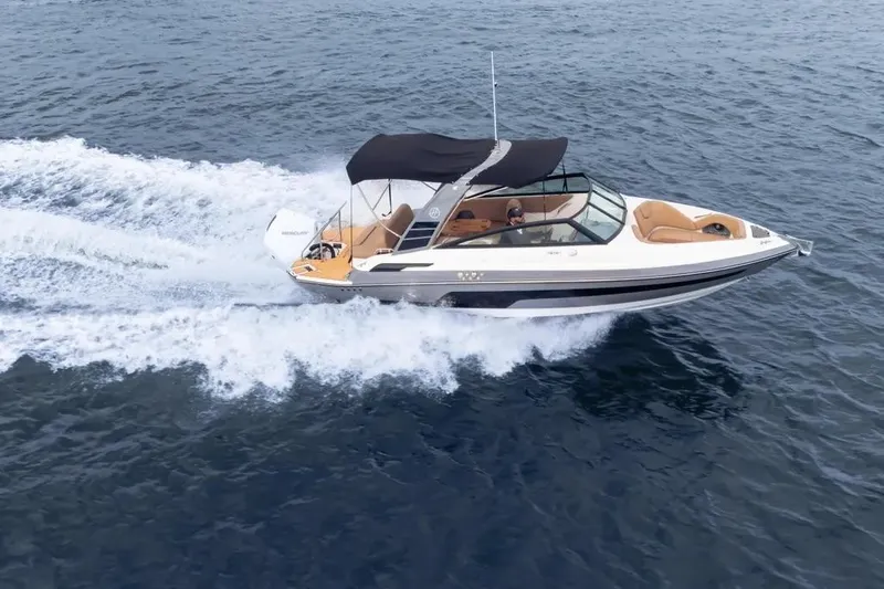  Yacht Photos Pics 2025 Hanover 255 boat cruising on open water with canopy and sleek design.