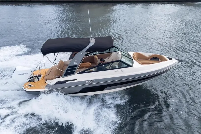  Yacht Photos Pics 2025 Hanover 255 boat cruising on water with black canopy and Mercury engine.