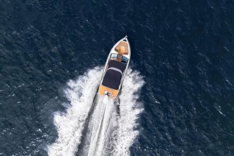  Yacht Photos Pics Aerial view of 2025 Hanover 255 boat cruising on open water.