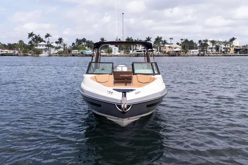  Yacht Photos Pics Front view of a 2025 Hanover 255 boat on calm water near a coastal area.