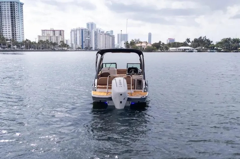  Yacht Photos Pics 2025 Hanover 255 boat on water with city skyline in background.