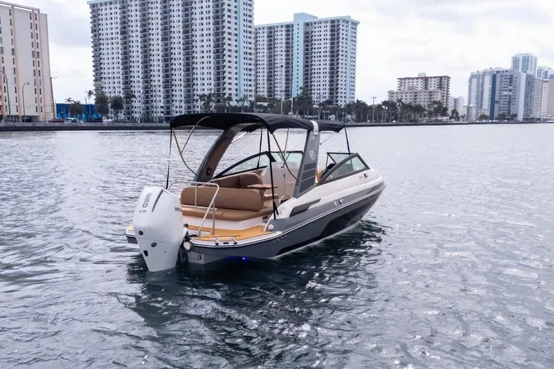  Yacht Photos Pics 2025 Hanover 255 boat on water with city skyline in background.