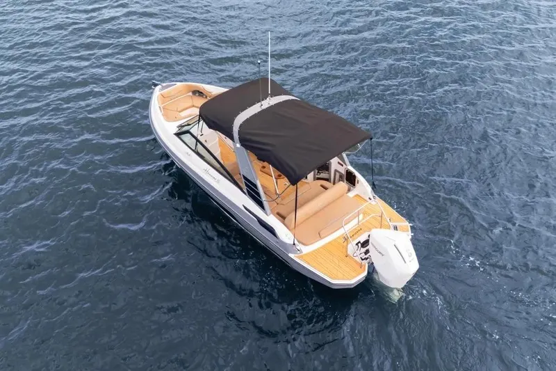  Yacht Photos Pics 2025 Hanover 255 boat with canopy on open water.