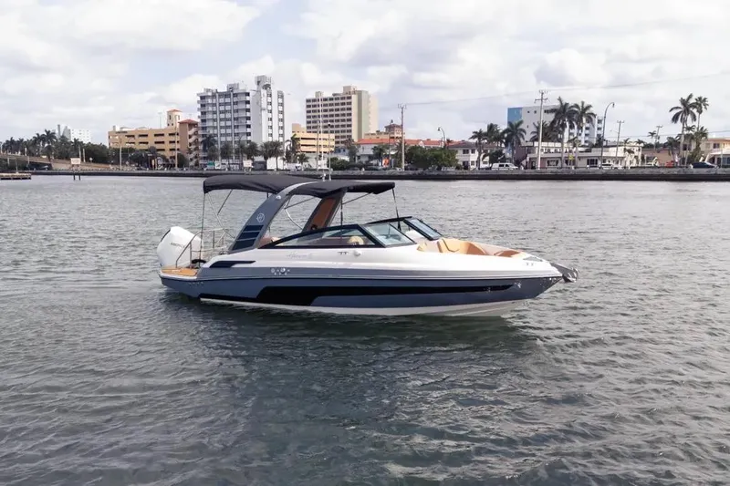  Yacht Photos Pics 2025 Hanover 255 boat on water with cityscape background.