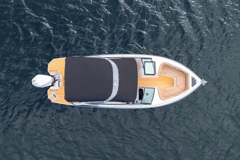  Yacht Photos Pics Aerial view of 2025 Hanover 255 boat on water, featuring sleek design and covered deck.
