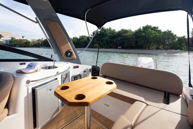  Yacht Photos Pics Luxurious 2025 Hanover 255 boat interior with seating, table, and scenic water view.