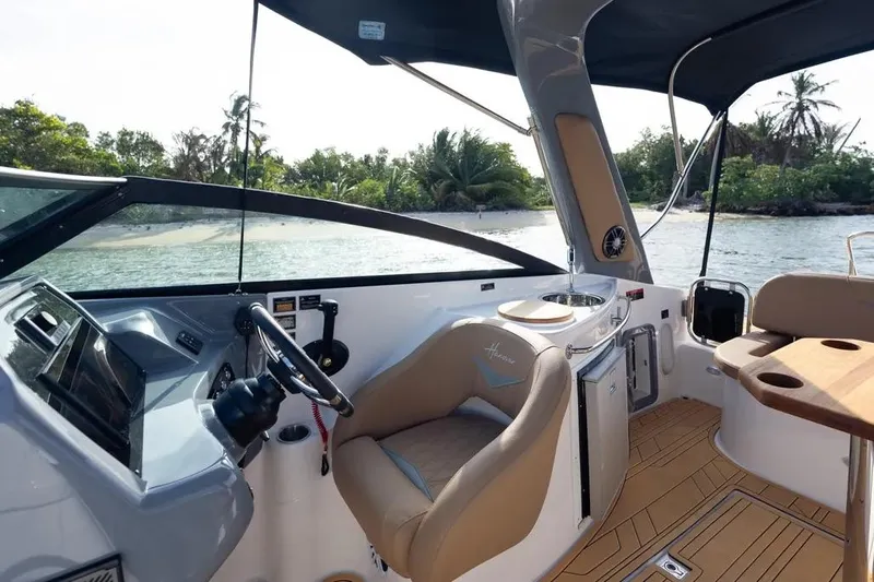  Yacht Photos Pics 2025 Hanover 255 boat interior with steering wheel, seating, and ocean view.