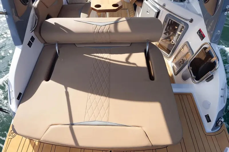  Yacht Photos Pics Luxurious seating area on a 2025 Hanover 255 boat with elegant tan upholstery.