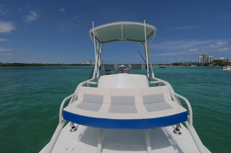 Alegria Yacht Photos Pics 2021 Yellowfin 54 Offshore boat on turquoise water under clear blue sky.