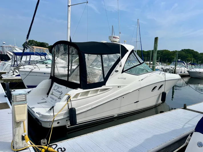 Sar Erinity Yacht Photos Pics 2009 Sea Ray 310 Sundancer docked at marina, featuring sleek design and black canopy.