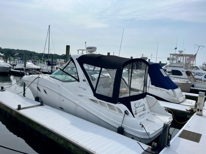 Sar Erinity Yacht Photos Pics 2009 Sea Ray 310 Sundancer docked at marina, featuring sleek design and black canopy.