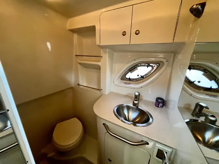 Sar Erinity Yacht Photos Pics 2009 Sea Ray 310 Sundancer bathroom with sink, toilet, and porthole window.