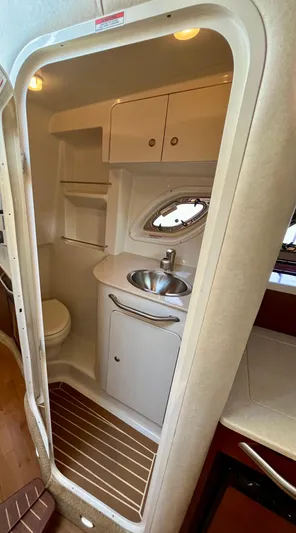 Sar Erinity Yacht Photos Pics 2009 Sea Ray 310 Sundancer bathroom with sink, toilet, and storage cabinets.