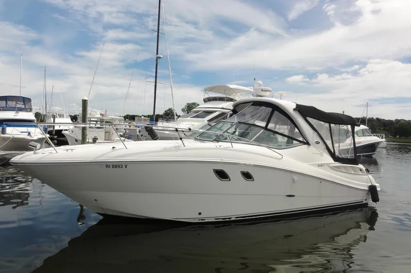 Sar Erinity Yacht Photos Pics 2009 Sea Ray 310 Sundancer boat docked in a marina under a partly cloudy sky.