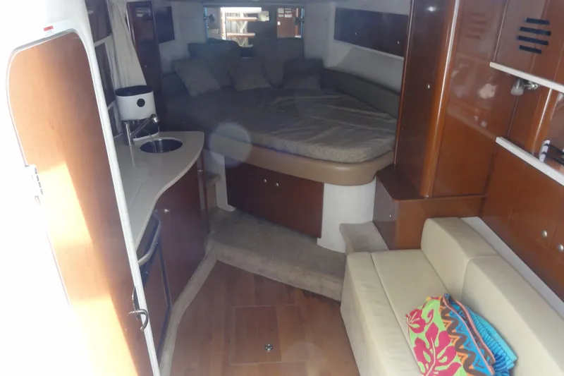 Sar Erinity Yacht Photos Pics Interior of 2009 Sea Ray 310 Sundancer yacht with cozy seating and compact kitchenette.