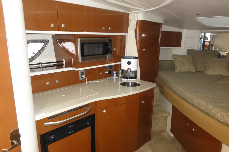 Sar Erinity Yacht Photos Pics 2009 Sea Ray 310 Sundancer interior with kitchenette, microwave, and cozy sleeping area.