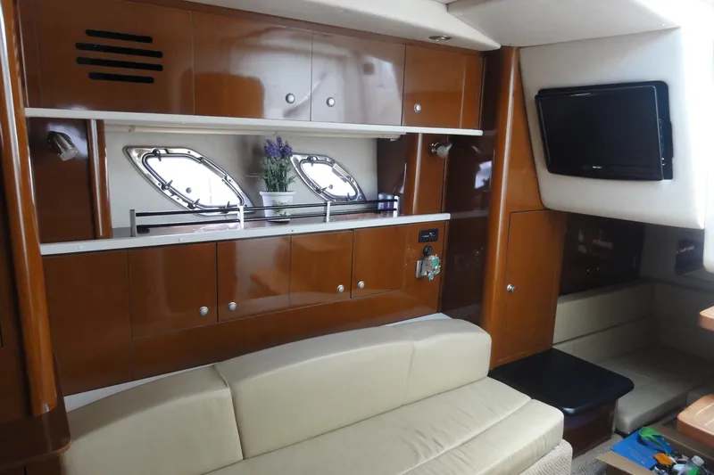 Sar Erinity Yacht Photos Pics Interior of 2009 Sea Ray 310 Sundancer yacht with wood cabinets and seating area.