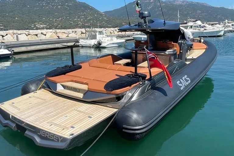 Nabu Yacht Photos Pics 2023 SACS Strider 15 luxury yacht docked in a scenic marina.