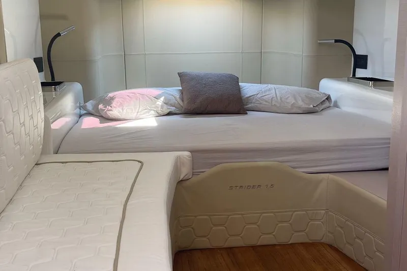 Nabu Yacht Photos Pics Luxurious interior of 2023 SACS Strider 15 yacht with comfortable bedding and modern lighting.