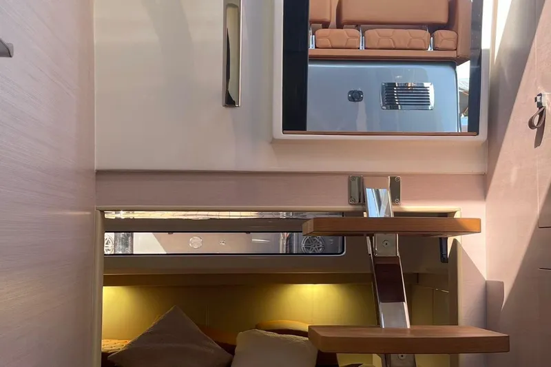 Nabu Yacht Photos Pics Interior view of 2023 SACS Strider 15 yacht, featuring modern stairs and cozy seating area.