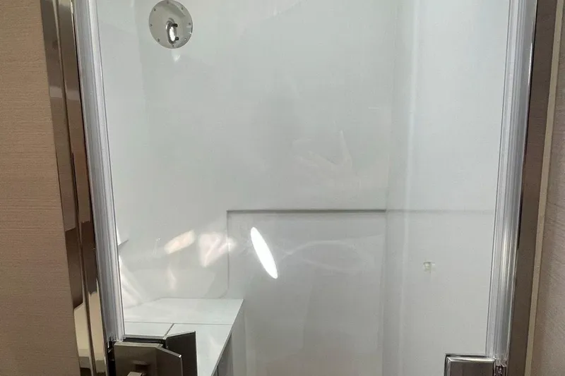 Nabu Yacht Photos Pics Shower area inside 2023 SACS Strider 15 yacht, featuring sleek glass door.