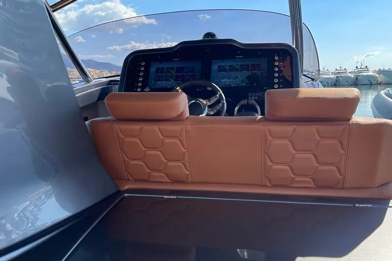 Nabu Yacht Photos Pics 2023 SACS Strider 15 cockpit with leather seats and modern dashboard controls.