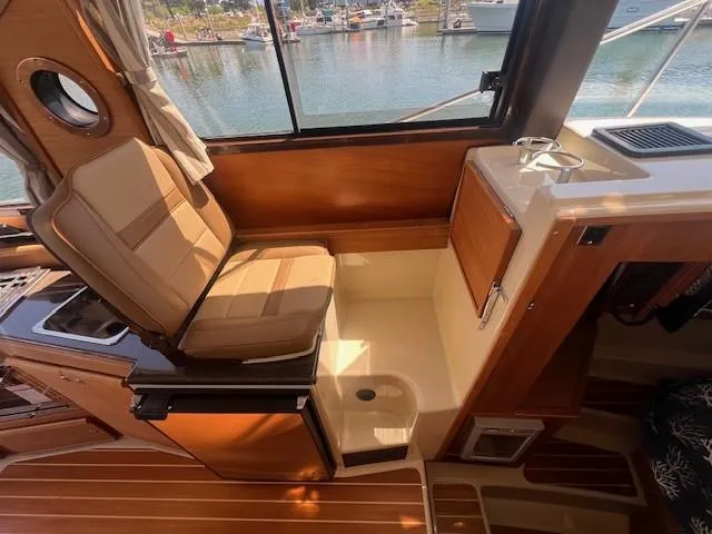 Red Diver Yacht Photos Pics Interior of 2022 Ranger Tugs R-29 S boat with seating and window view.