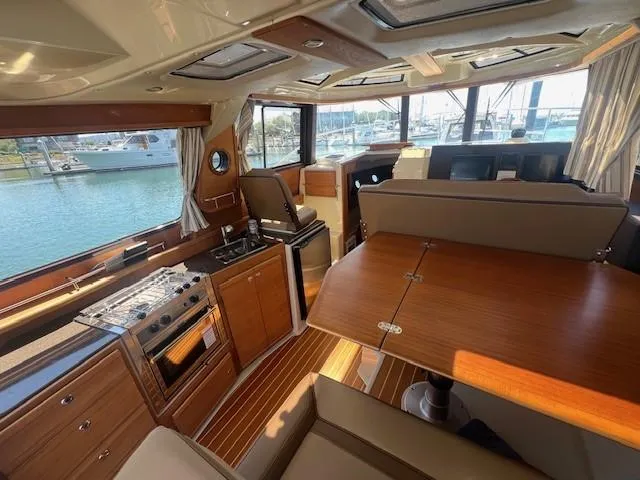 Red Diver Yacht Photos Pics Interior of 2022 Ranger Tugs R-29 S boat with wood finishes and waterfront view.