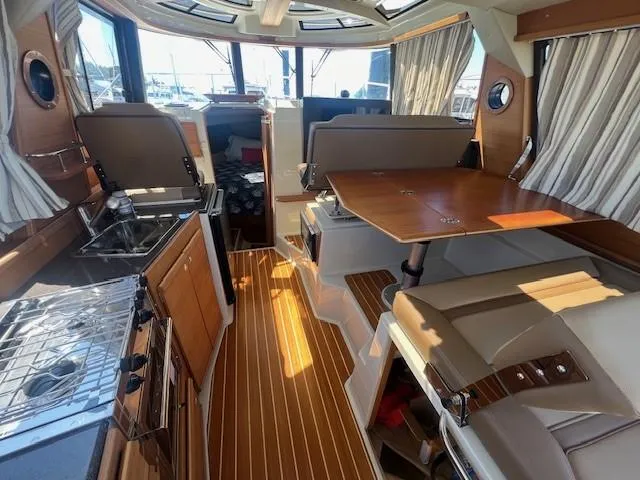 Red Diver Yacht Photos Pics Interior of 2022 Ranger Tugs R-29 S boat with wood accents and seating area.
