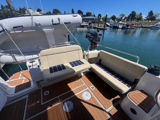 Red Diver Yacht Photos Pics 2022 Ranger Tugs R-29 S boat deck with seating, docked by a marina.