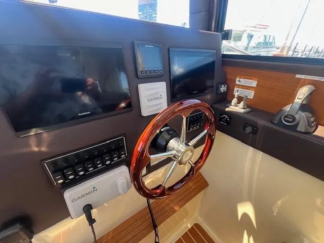 Red Diver Yacht Photos Pics 2022 Ranger Tugs R-29 S helm with Garmin displays and wooden steering wheel.