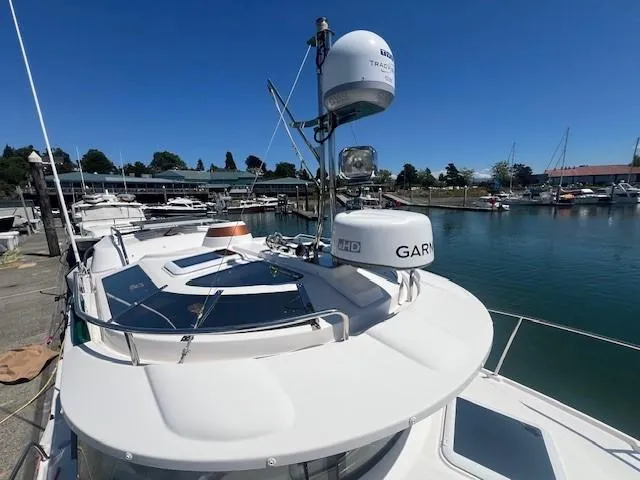Red Diver Yacht Photos Pics 2022 Ranger Tugs R-29 S boat docked at marina under clear blue sky.