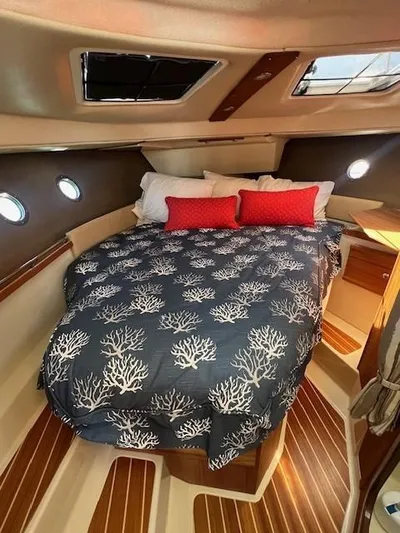 Red Diver Yacht Photos Pics 2022 Ranger Tugs R-29 S cabin interior with cozy bed and nautical decor.