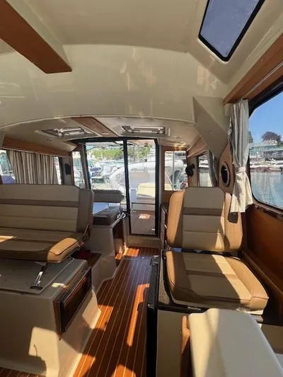 Red Diver Yacht Photos Pics Interior of 2022 Ranger Tugs R-29 S boat with seating and wood flooring.