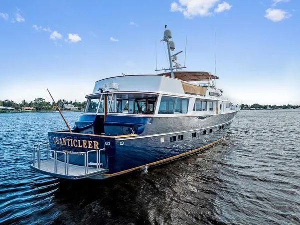 Chanticleer Yacht Photos Pics Classic 1973 Burger 310C yacht "CHANTICLEER" on open water under blue sky.