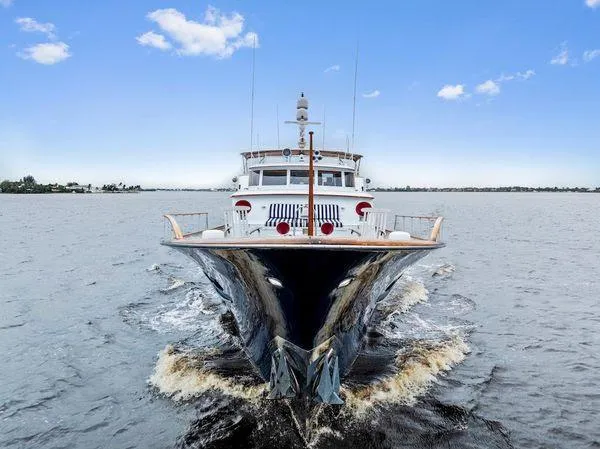 Chanticleer Yacht Photos Pics Front view of a 1973 Burger 310C yacht cruising on open water.