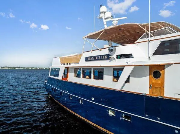 Chanticleer Yacht Photos Pics Classic 1973 Burger 310C yacht on open water under clear blue sky.