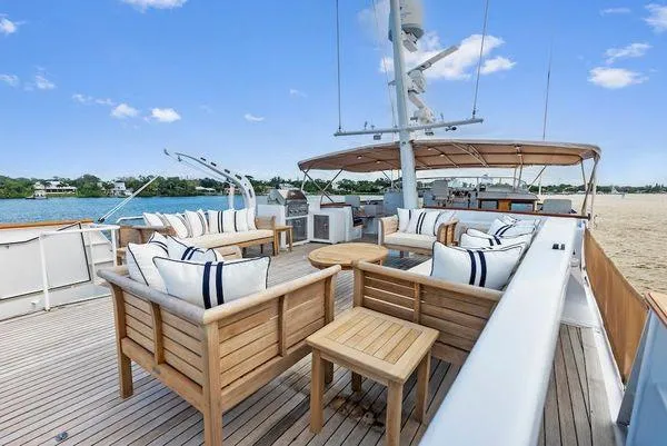 Chanticleer Yacht Photos Pics Luxurious 1973 Burger 310C yacht deck with elegant wooden seating and scenic water view.