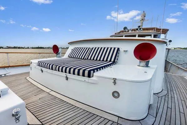 Chanticleer Yacht Photos Pics 1973 Burger 310C yacht deck with striped seating and nautical design.